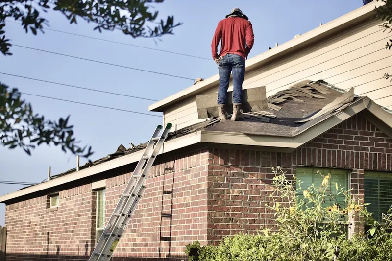 Professional roofer working on a residential roof in Twin River Golf Club